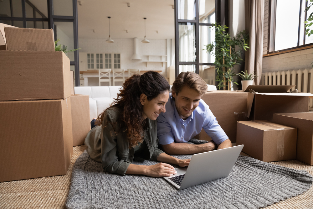 Enthusiastic,Millennial,Spouses,Buyers,Renters,Of,New,Flat,Lie,On Millenial couple in their new rental space search online for affordable renters insurance.