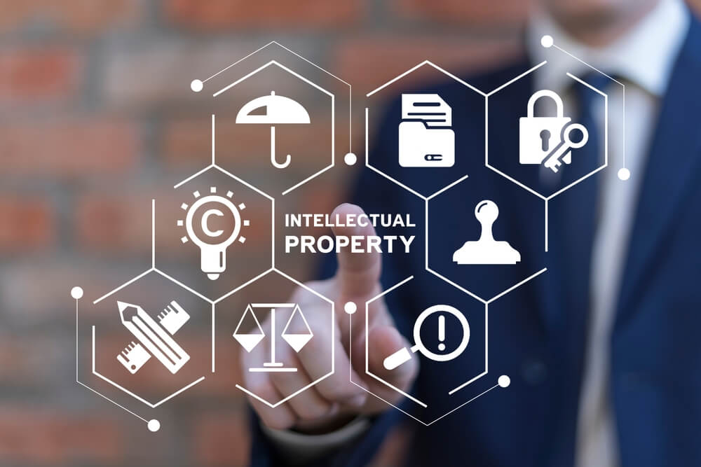 ino-how-business-insurance-protects-your-intellectual-property-and-trade-secrets-1 Business man working on virtual touch screen presses inscription: INTELLECTUAL PROPERTY. How business insurance can help you protect intellectual property and trade secrets.