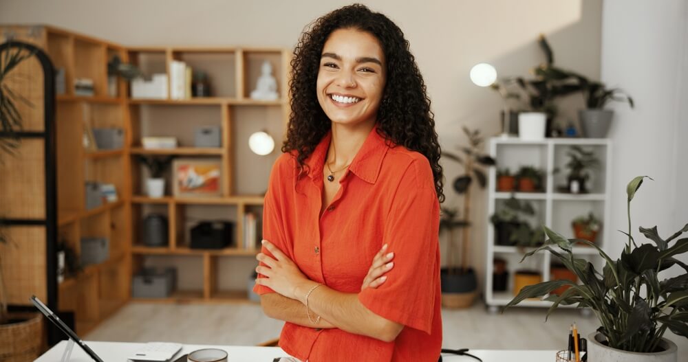 ino-how-to-tailor-business-insurance-to-your-unique-needs-with-insureone-1 Small business, portrait and woman with arms crossed, confident and smile for sales in flower and gift shop, happy with small business insurance coverage.