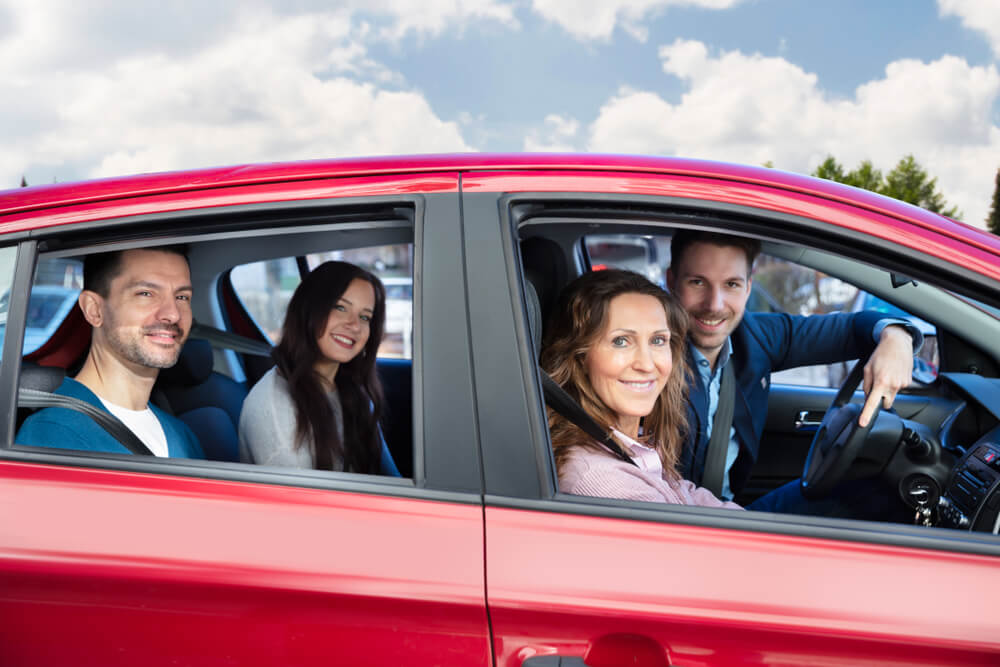 Group Of Happy Friends Having Fun In The Car, carpooling to lower insurance rates during commute.