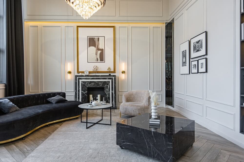 A bright, luxurious modern living room with historical details and a marble fireplace — the kind of space where high-value item insurance truly matters.