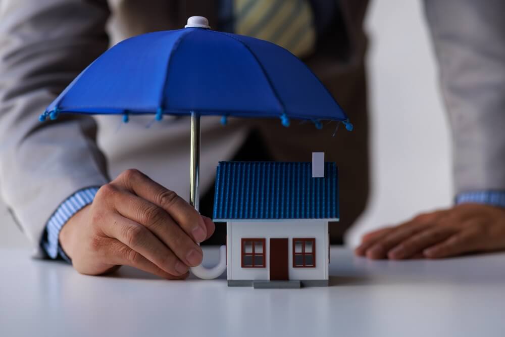 Concept of umbrella insurance with an umbrella over a business.