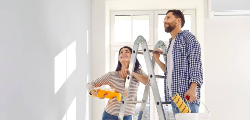 Couple painting and renovating their home, highlighting the importance of a home improvements insurance review before starting projects.