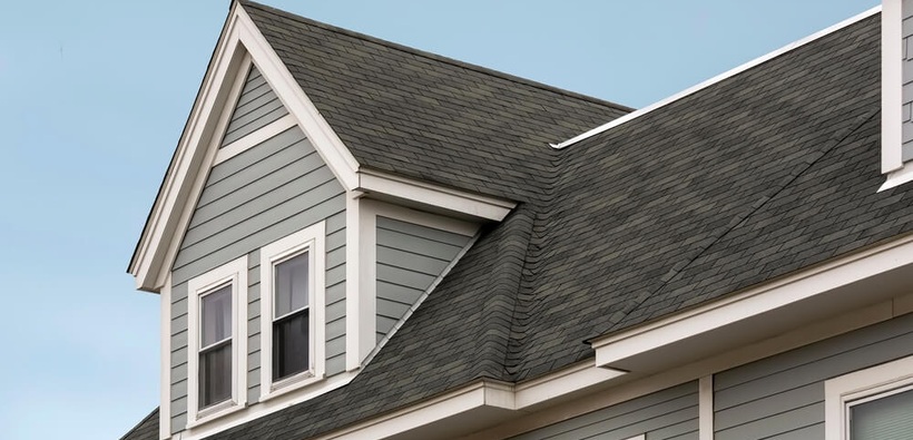 Home roof with asphalt shingles for roof replacement coverage.