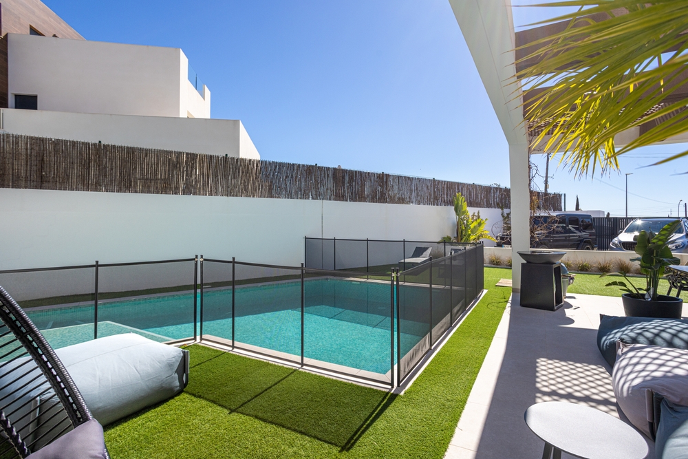Fenced backyard swimming pool at a modern home, highlighting home insurance and pool safety considerations.