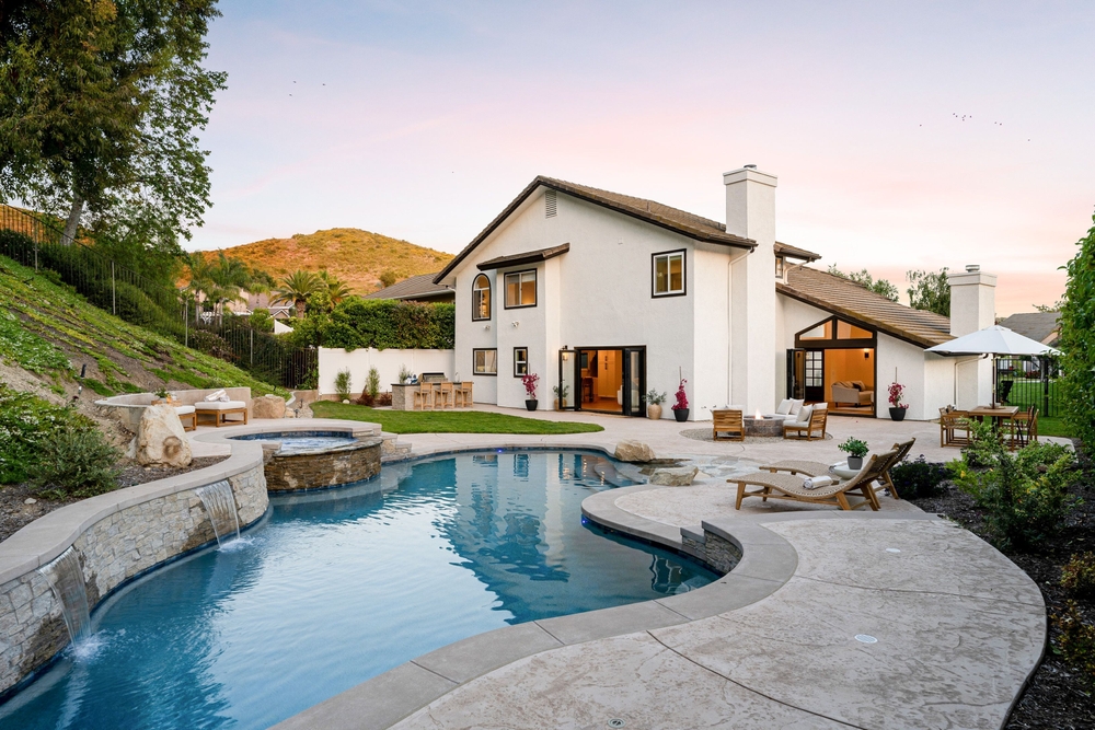 Backyard swimming pool at a home with outdoor patio and seating, highlighting home insurance considerations.