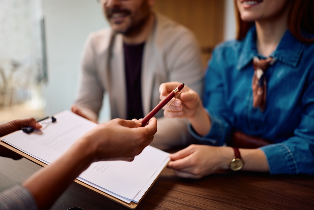 Business owners reviewing insurance documents with an agent, representing business insurance across states.