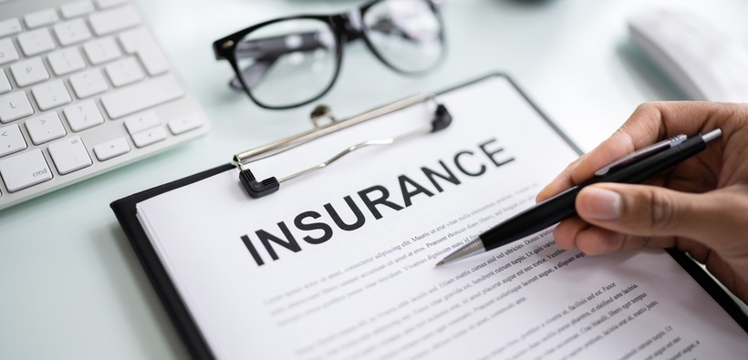Business owner reviewing an insurance policy to understand LLC insurance needs.