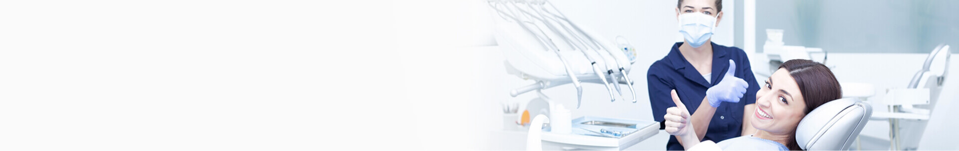 Smiling woman getting dental work with dentist giving thmbs up