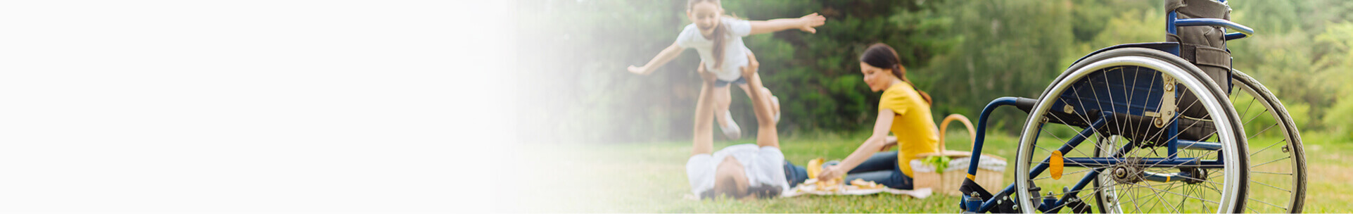 Front view of a wheelchair with a happy family playing in the part on the background