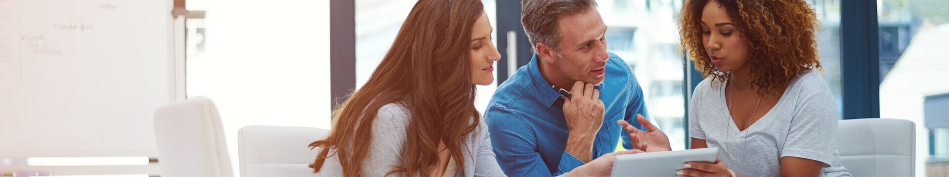 Couple with an female insurance agent getting answers to their frequently asked questions