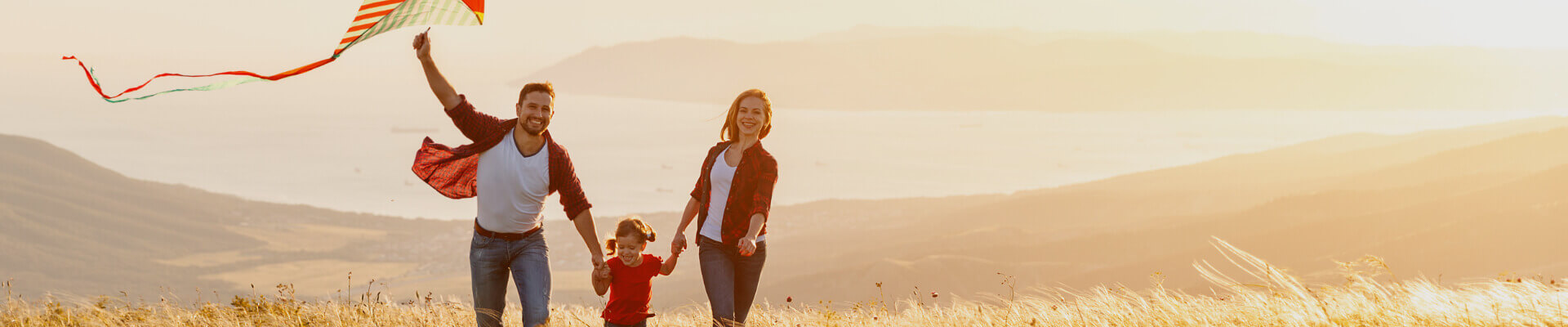 Happy family with a small child flying a kite