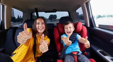 Woman and child giving a thumbs up.