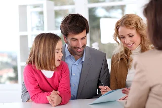 Family signing insurance policy adding comprehensive coverage.