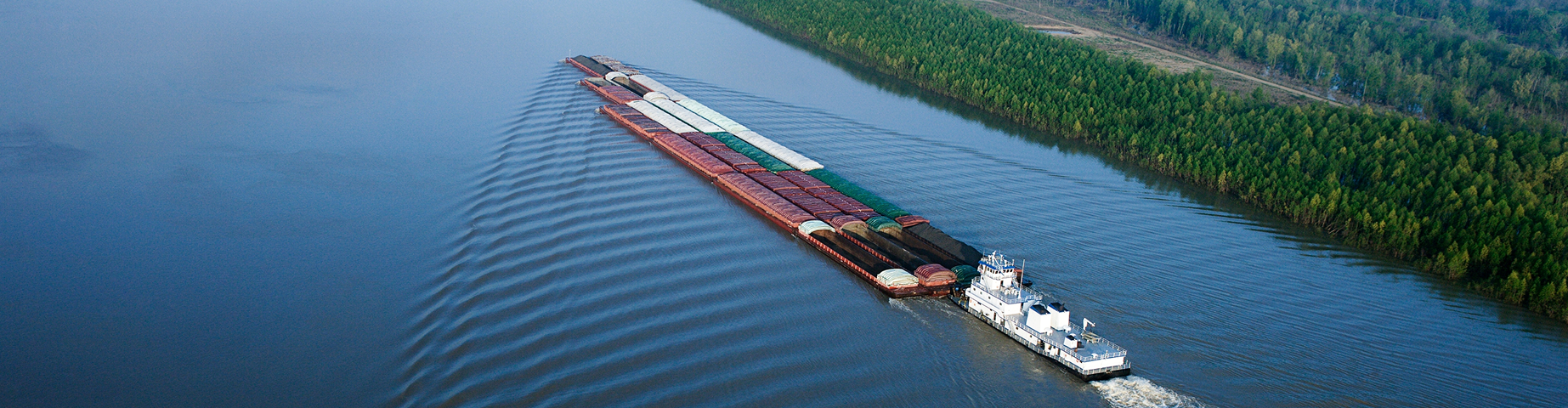 Aerial of barge on Mississippi River in Baton Rouge - best home insurance in Louisiana.