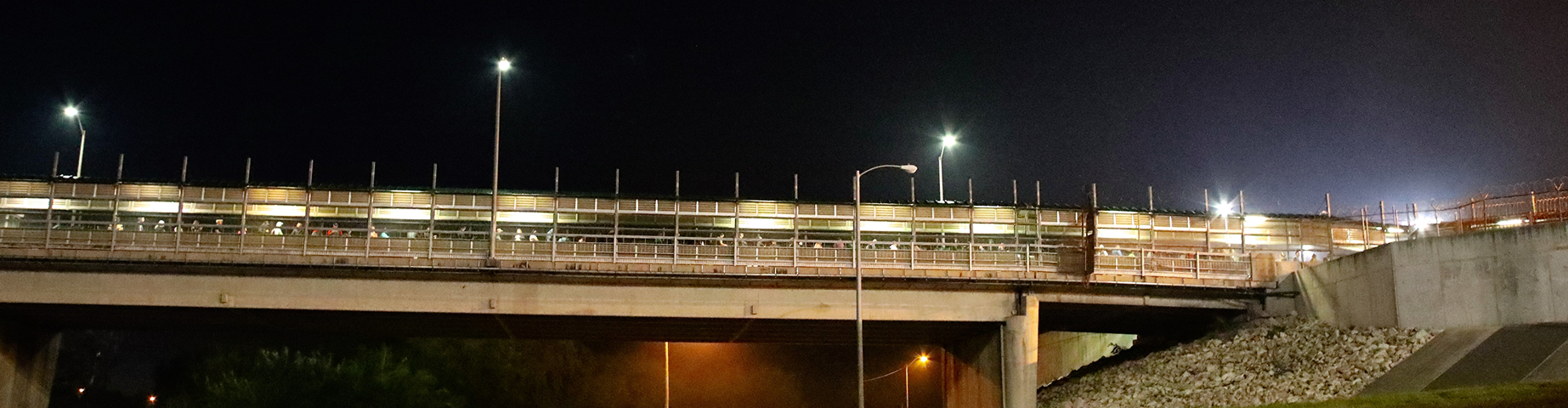 Mission, TX, USA - March 22, 2024: People walk across the International Bridge from Reynosa, Mexico to McAllen, Texas to go to work and school shortly before sunrise.