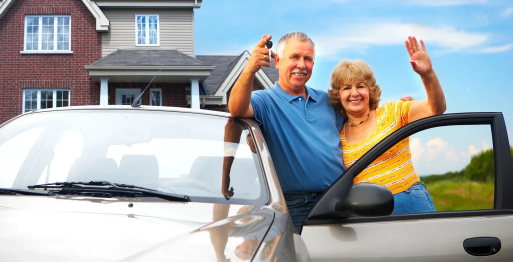 Elderly couple near their home. Real estate and insurance bundling concept.