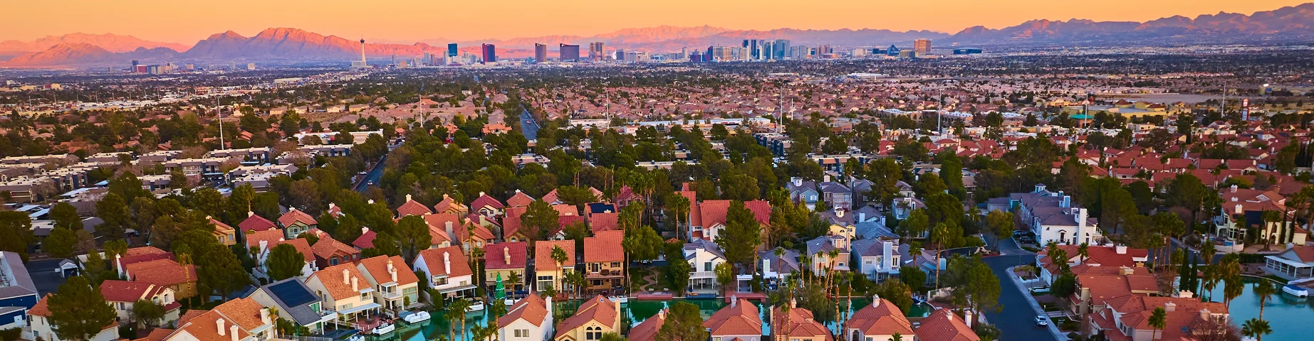 Aerial Waterfront Suburb with Las Vegas Skyline at Sunset