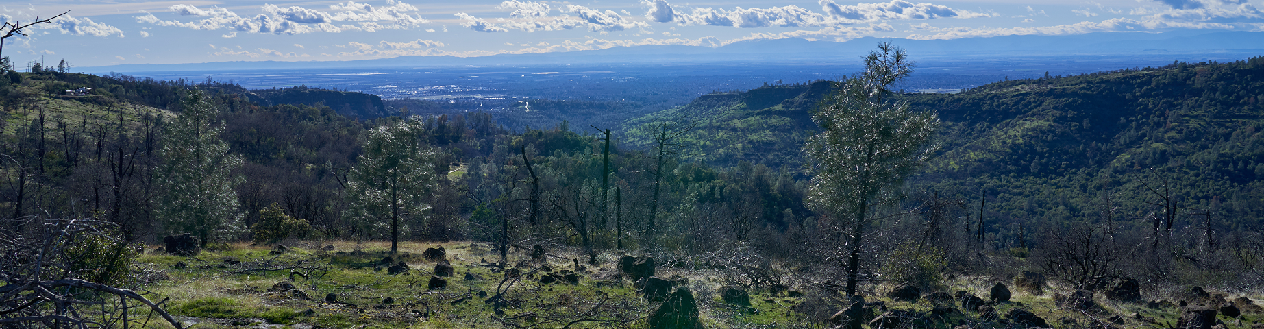 Mountain view with blue skies and white clouds overlooking Chico – best homeowners insurance in California.