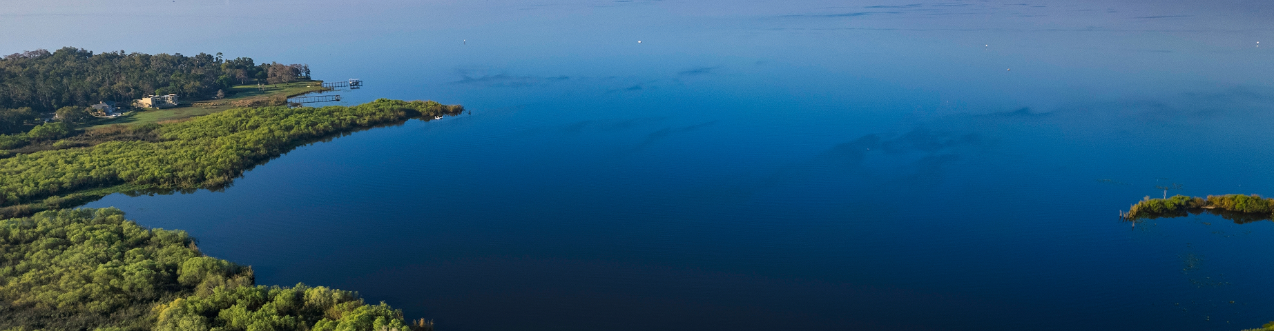 Aerial photo of Lake Monroe on an early morning, view from Deltona - great home insurance in Florida.