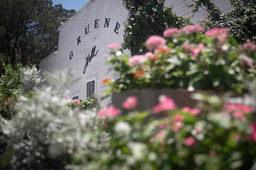 Gruene Hall with flowers in the foreground - best car insurance in Texas.