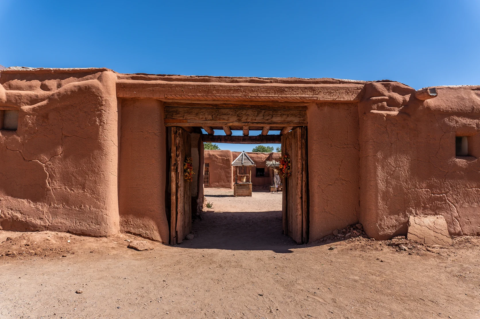 El Rancho de Las Golondrinas (The Ranch of the Swallows), historic rancho, now a living history museum near Santa Fe, New Mexico. Zaguán (covered entryway) to Las Golondrinas Placita with adobe walls.