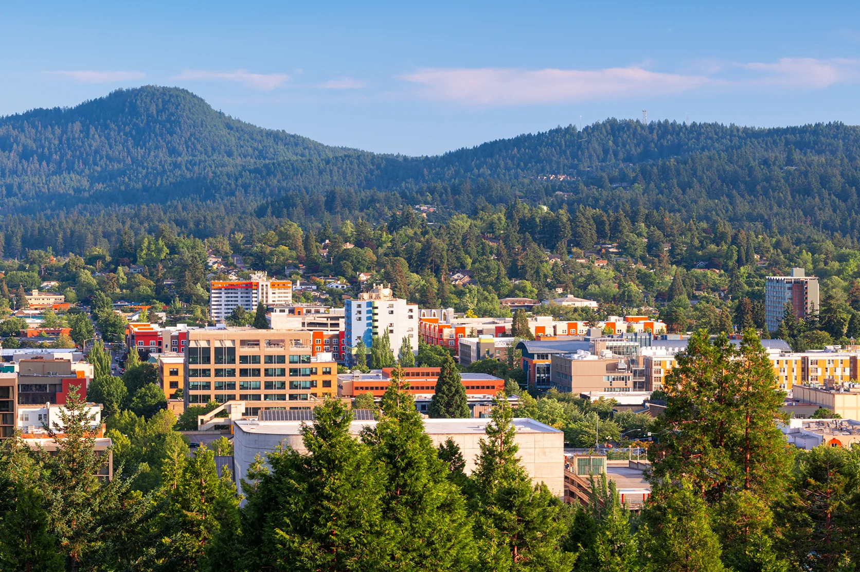 Eugene, Oregon, USA downtown cityscape and mountains in the afternoon.