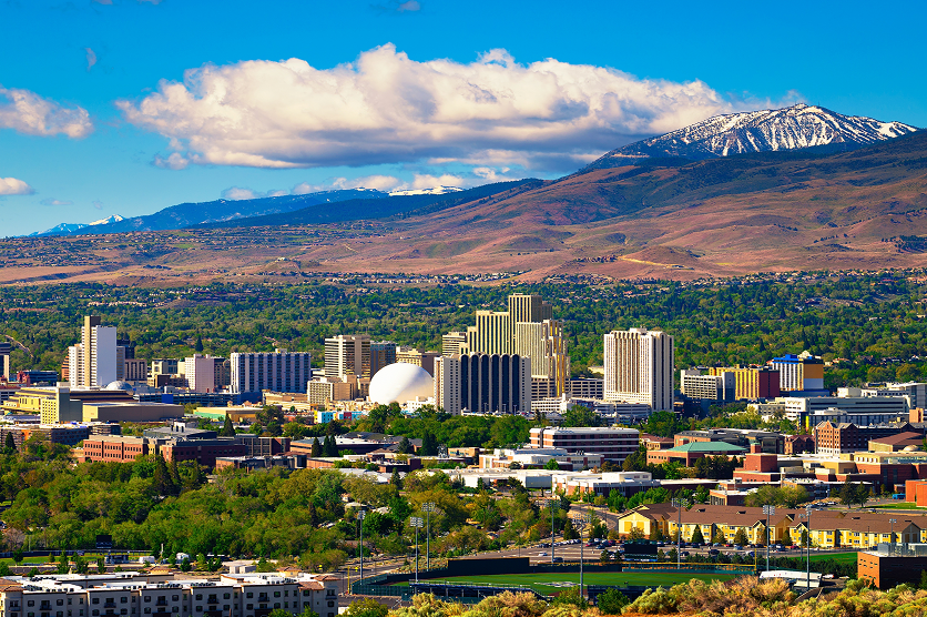 Downtown Reno skyline, Nevada, with hotels, casinos and the surrounding High Eastern Sierra foothills