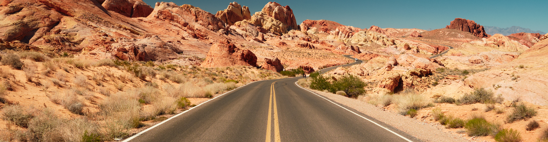 USA, Nevada, Valley of Fire State Park, straight road leading through rocky desert landscape.