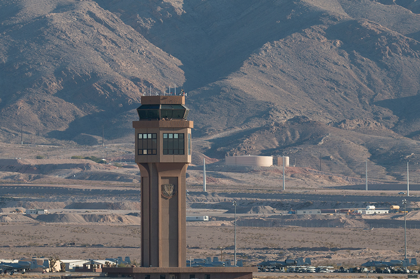 Control tower with mountains in the background of Nellis air force base in Nevada.