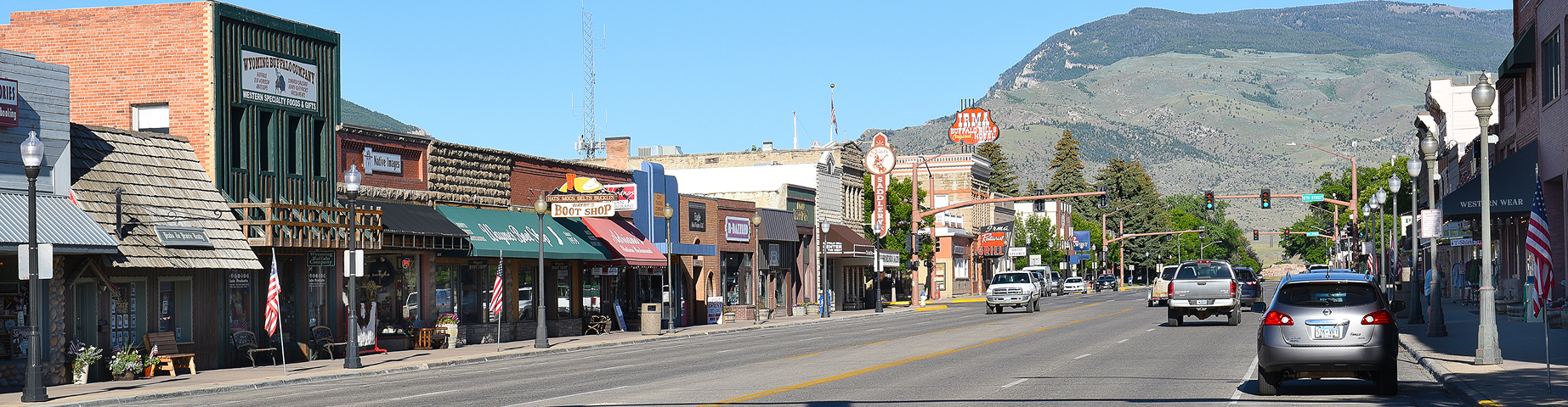 Small town main street in Wyoming with vehicles and local shops, illustrating everyday driving and wyoming car insurance coverage.