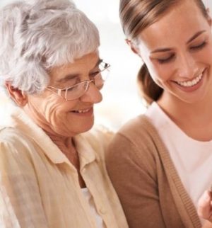 Older woman and younger woman look at a pearl necklace together, showing why valuable items home insurance may not fully cover may need extra protection.