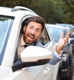 Guy driving angry in traffic good thing he has quality car insurance in case something happens.