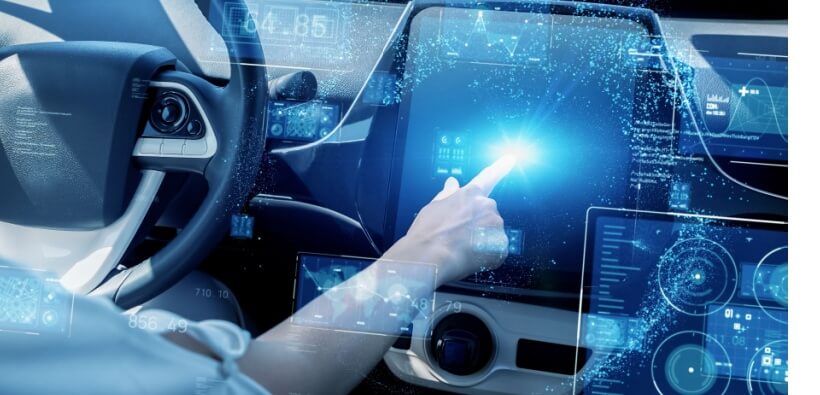 Inside a modern car, a driver reaches toward a glowing digital touchscreen surrounded by holographic driving data, evoking how telematics auto insurance uses real-time technology to track driving habits and create safer, more personalized coverage.