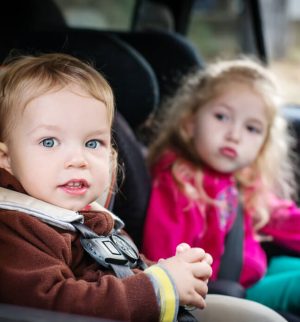 cute small children in car seats in the car
