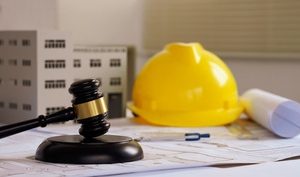 Mazo judicial, casco de construcción y planos que representan ordinance and law coverage.