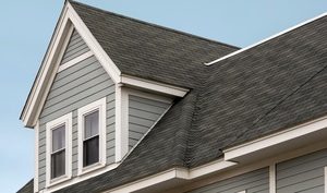 Home roof with asphalt shingles for roof replacement coverage.