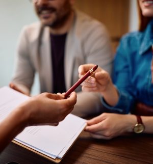 Business owners reviewing insurance documents with an agent, representing business insurance across states.