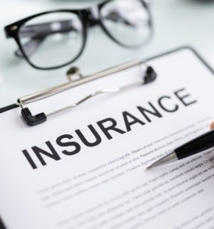 Business owner reviewing an insurance policy to understand LLC insurance needs.